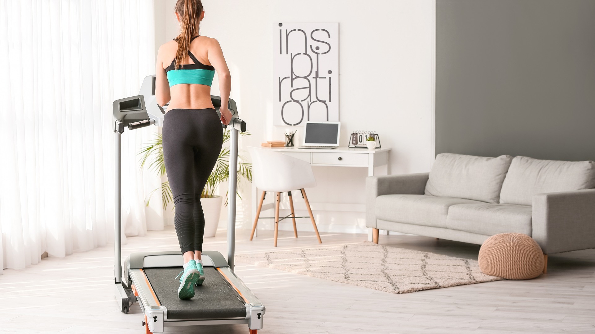 Woman running in her living room on a treadmill