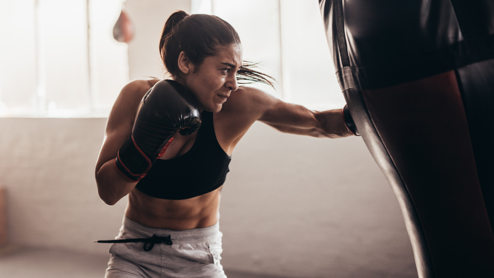 Woman practicing boxing with a bag