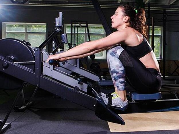 woman exercising with rowing machine