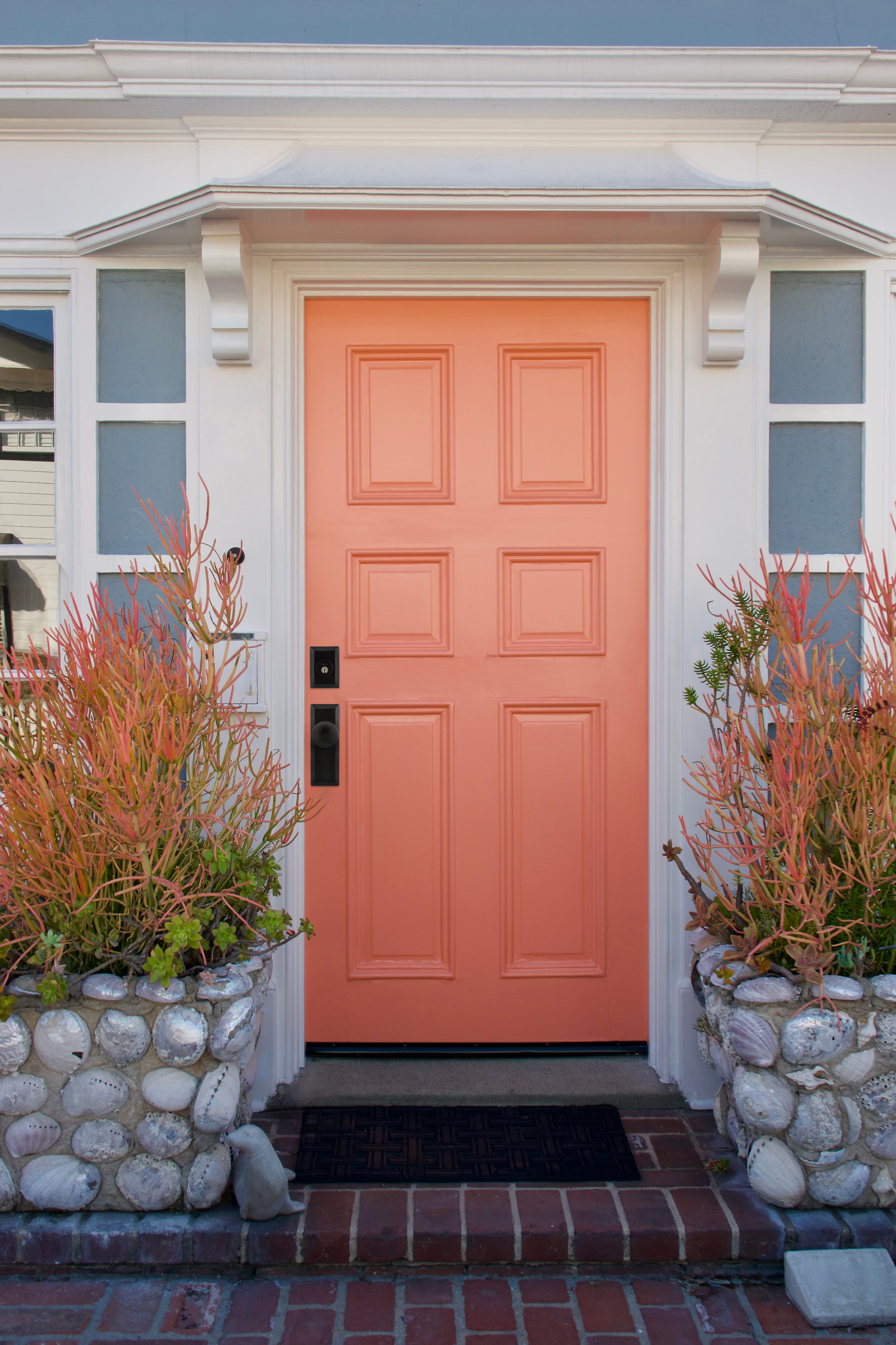 Peach Fuzz colored exterior door with a Keep plate and Keep doorknob on it.