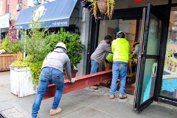 Construction workers bring steel beams into Greene Grape Provisions in Fort Greene, Brooklyn.