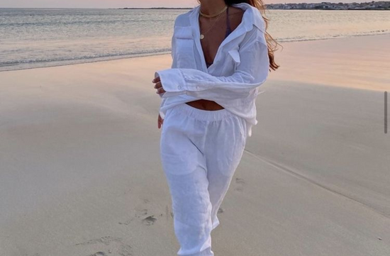 girl on the beach wearing petite linen pants in white