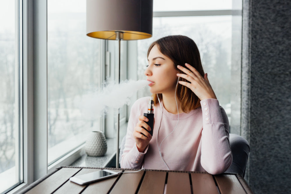 Woman vaping in a café