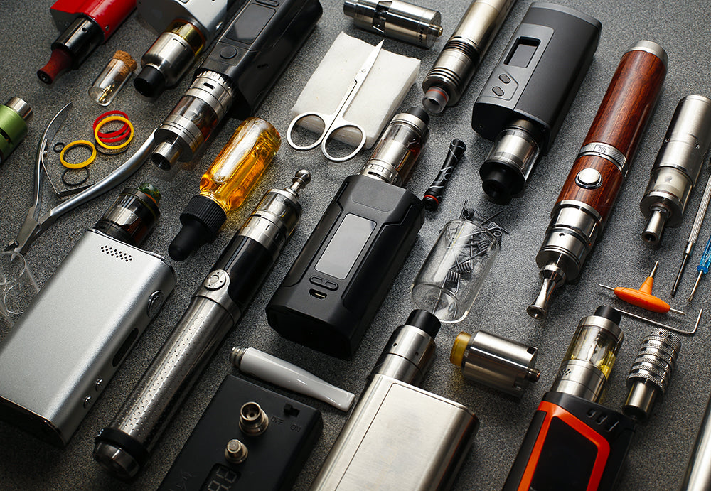 collection of vaping devices, coils and e-liquids