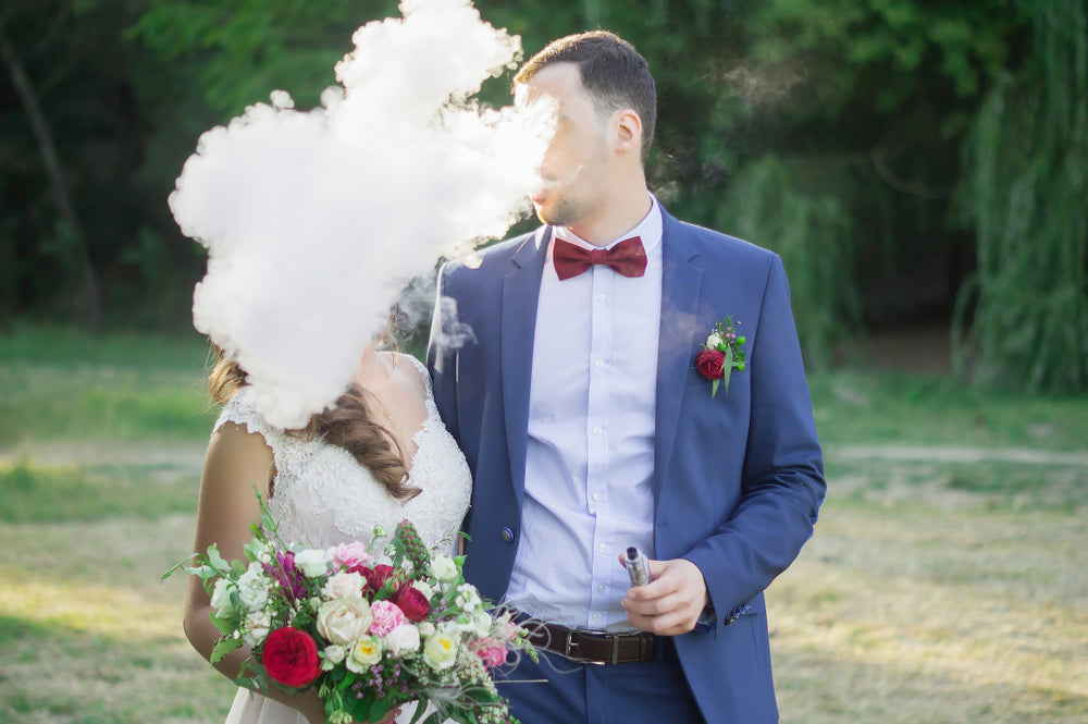 Happy couple vaping to each other on their wedding day