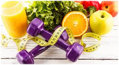 Purple dumbbells' next to fruits and vegetables on wood table