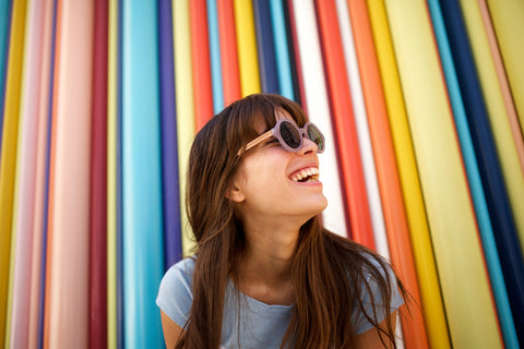 Women Smiling with rainbow background