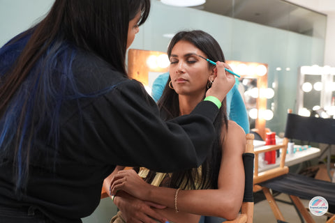 makeup artist applying makeup on model