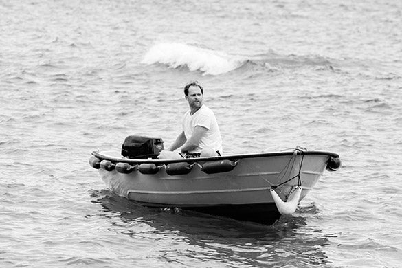 riz boardshorts co-founder ali murrell driving a tender across the sea back to shore
