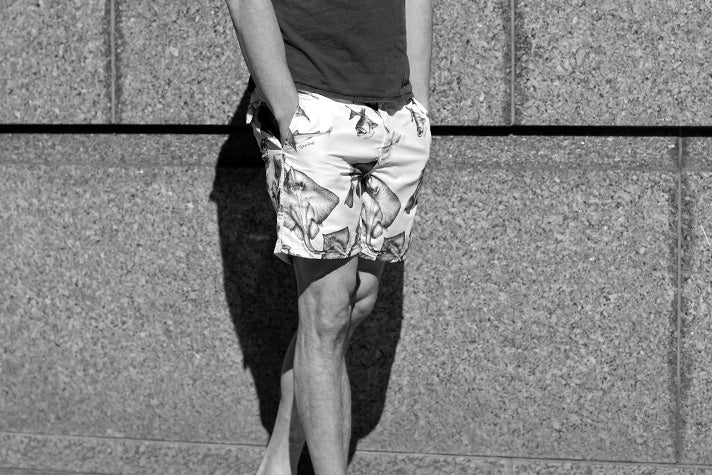 riz boardshorts endangered fish print short worn by a model in front of a wall