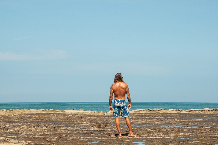 model stood on reef in costa rica wearing riz swim shorts