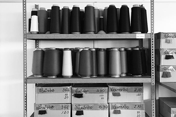 Rolls of thread on a shelf in a garment factory where Riz swim shorts are manufactured 