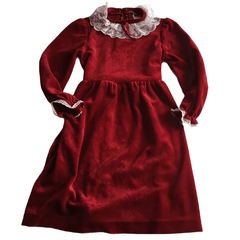 A young girls red velvet dress