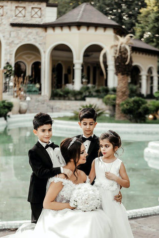 a bride and three children wearing Party Clothes