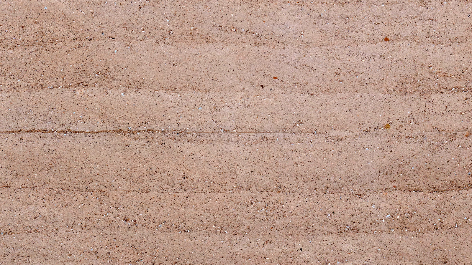 Photo showing the layers of a rammed earth wall