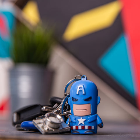 Captain America keychain figure standing in front of extremely blurred surroundings which included a custom-crafted decoration for a giftopiia gift box.