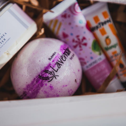 Collection of gifts in a white gift box with Bubblzz' lavender bath bomb being the focus.