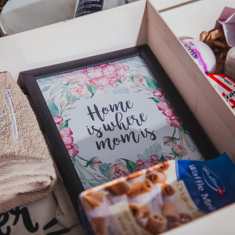 Collection of gift items in a white gift box with elegant picture frame being the focus