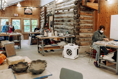 Students in the Anderson Ranch Soldner Ceramics Studio during a ceramics workshop called "Decorative Surfaces at Mid Range." Students practice hand building techniques (e.g., coil and slab construction) as well as throwing on the wheel with some simple altering with the goal of learning to sculpt and glaze simple, elegant, cohesive forms.