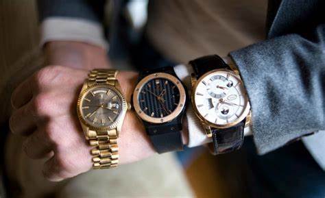 Close up of a man’s wrist with multiple watches