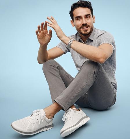 Man wearing a polo, jeans, and athletic sneakers