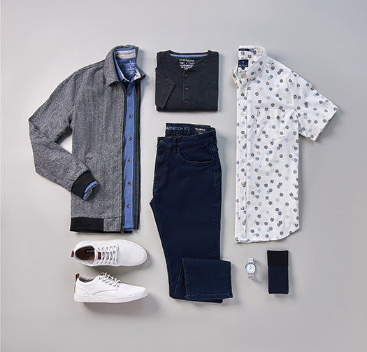 Flat Lay clothing, short sleeve patterned  button down, henley tee, dress shirt under jacket, dark denim, watch, socks, and sneakers.