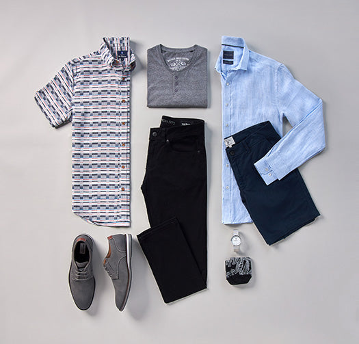 Flat Lay clothing, short sleeve patterned  button down, henley tee, dress shirt, shorts, black denim, watch, socks, and dress shoes.