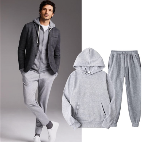 Grey sweatpants and hoodie combo against a white background.