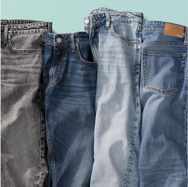 4 pairs of jeans, each of a different wash, on a turquoise background.