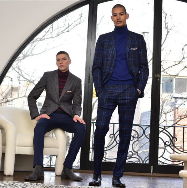 A man wearing a plaid blazer and a second man wearing a windowpane suit