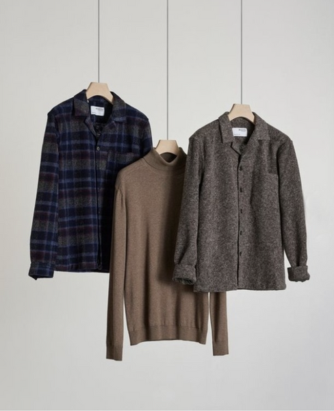 A hanging flannel, sweater, and wool jacket