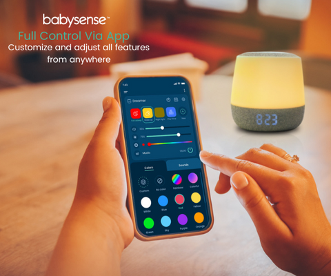 Babysense Dreamer sound and light machine. Showing the application and in the background the night light
