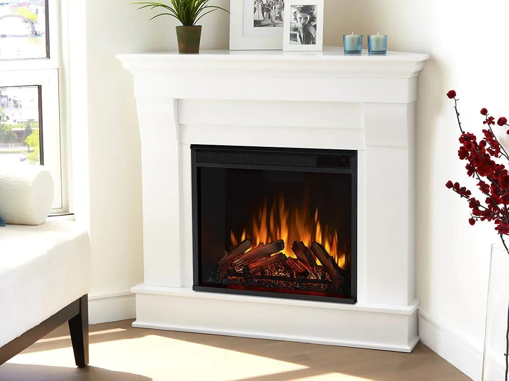 Classic white colonial style fireplace made for the corner in a bright living room.