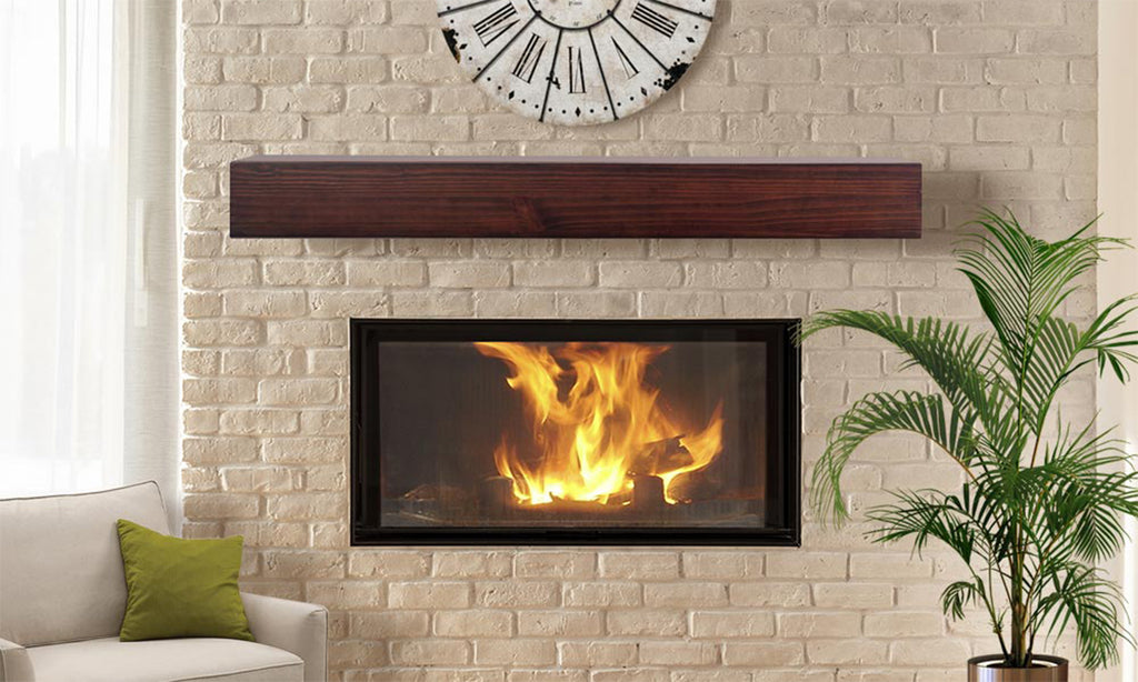 Fireplace on a light brick wall with wood slab mantel over the top.