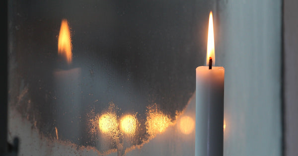 Candles on the fireplace mantel.