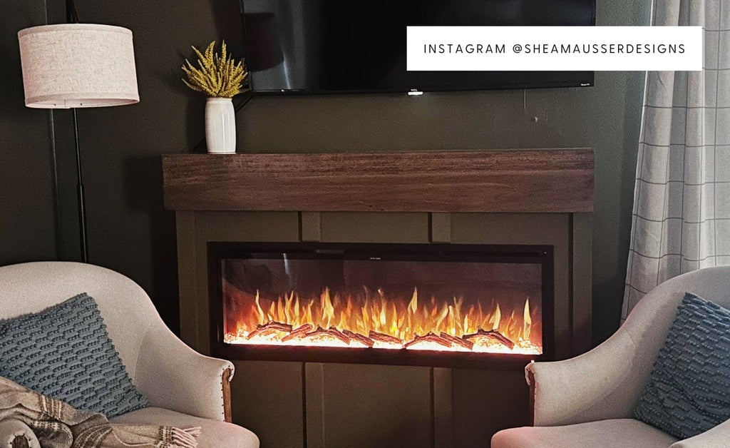 Linear electric fireplace installed in a board and batten bump out with two cozy chair in front.