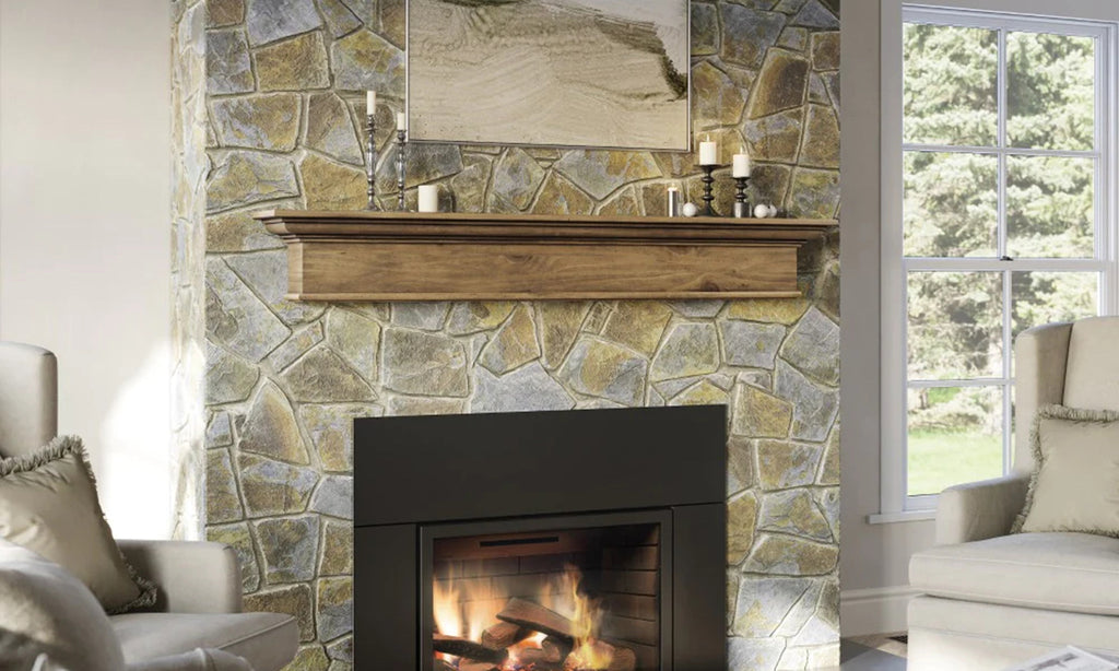 Farmhouse style wood mantel shelf over a fireplace in a rock surround. 