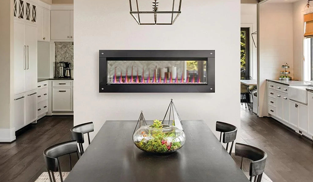 Electric fireplace mounted on a wall in a dining room with white walls and large dining table.