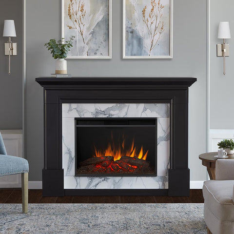 A black mantel with white marble surround on an electric fireplace.