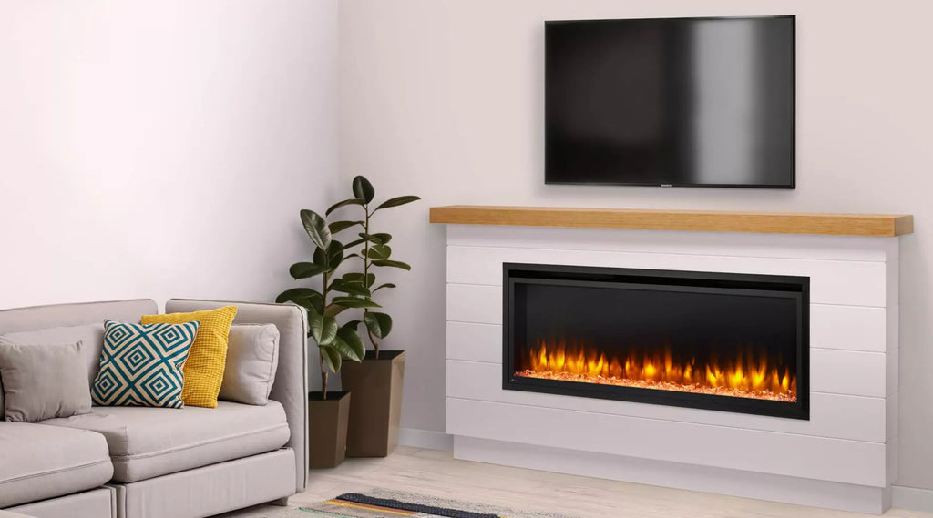 Linear electric fireplace with wood mantel and television above the mantel.