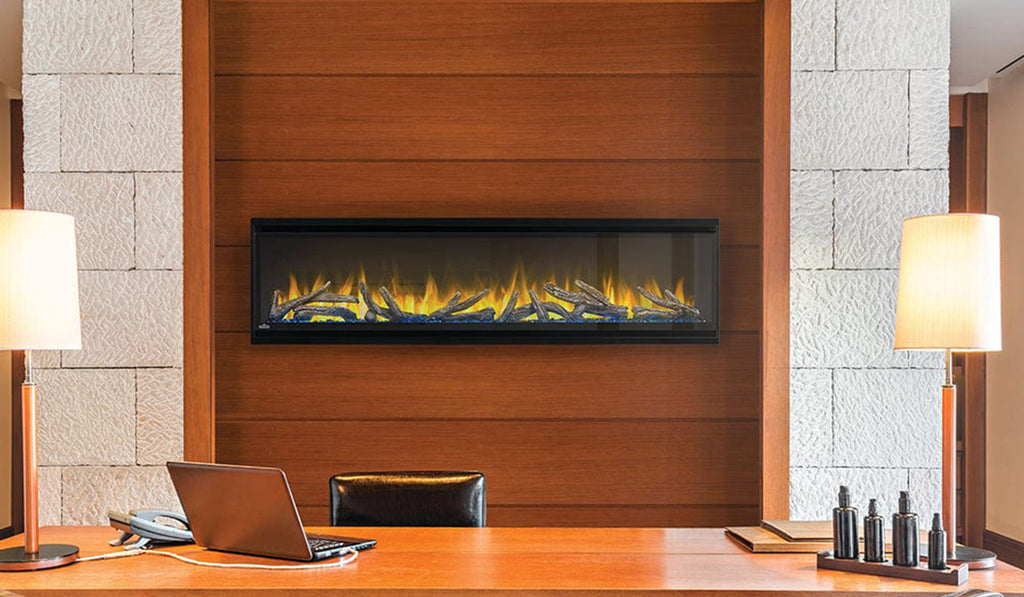 Linear electric fireplace in a wood full wall surround and no mantel.