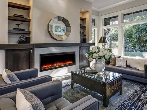 Large living room with linear electric fireplace with gray furniture and metallic accents.