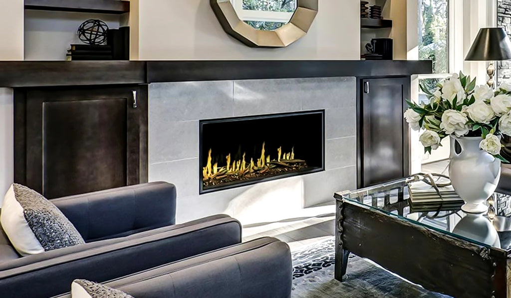 Linear electric fireplace in a white brick hearth with long wood mantel overhead.