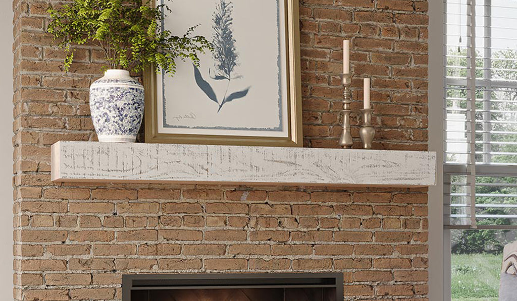 Fireplace with white wood mantel and brick surround.