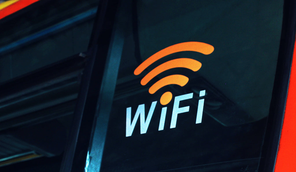 Large black sign with wifi symbol lit up in orange and blue.