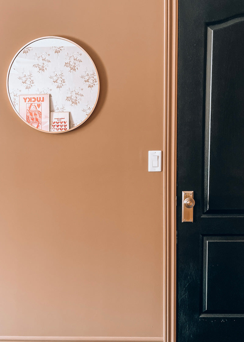 black door vintage brass hardware grandeur luxury pink wall