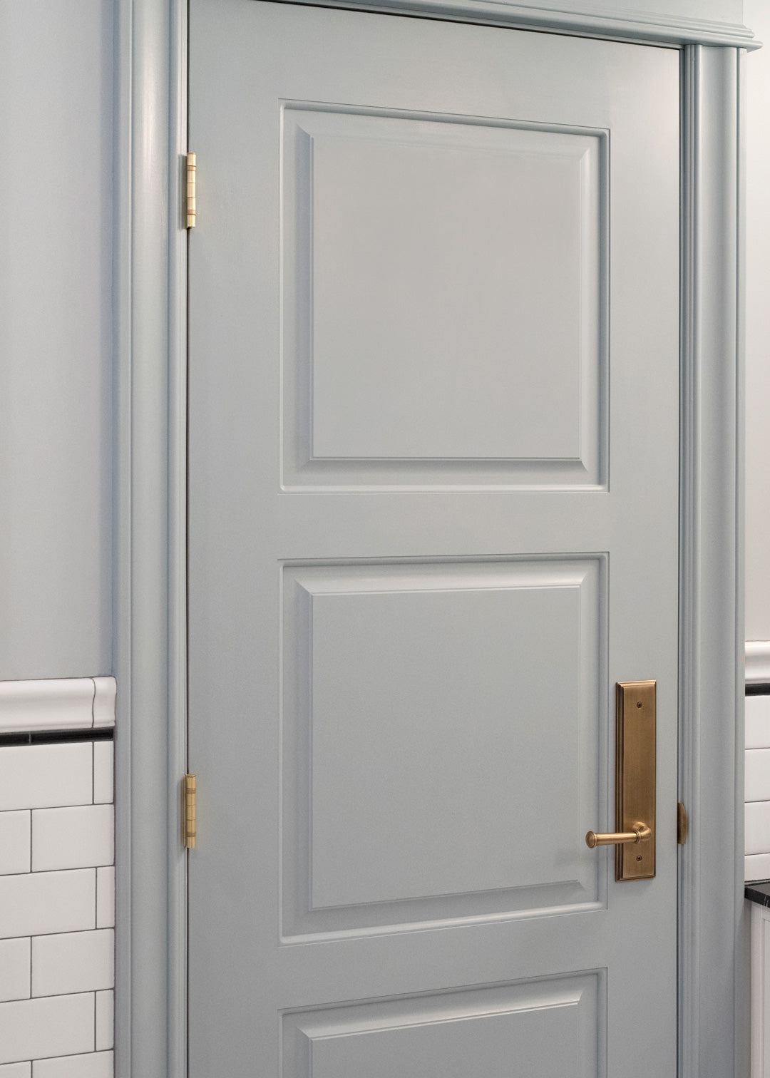 room for tuesday blue wall white door luxury brass door hardware