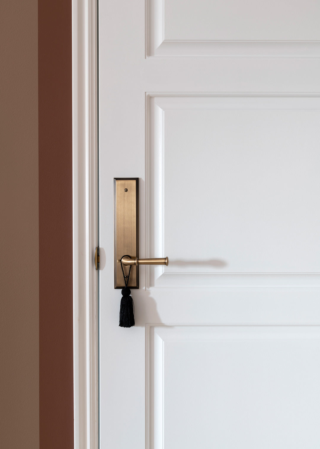 room for tuesday pink red wall white door luxury brass door hardware