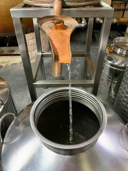 New make whisky flowing off the spirit stills after distillation at Bimber Distillery