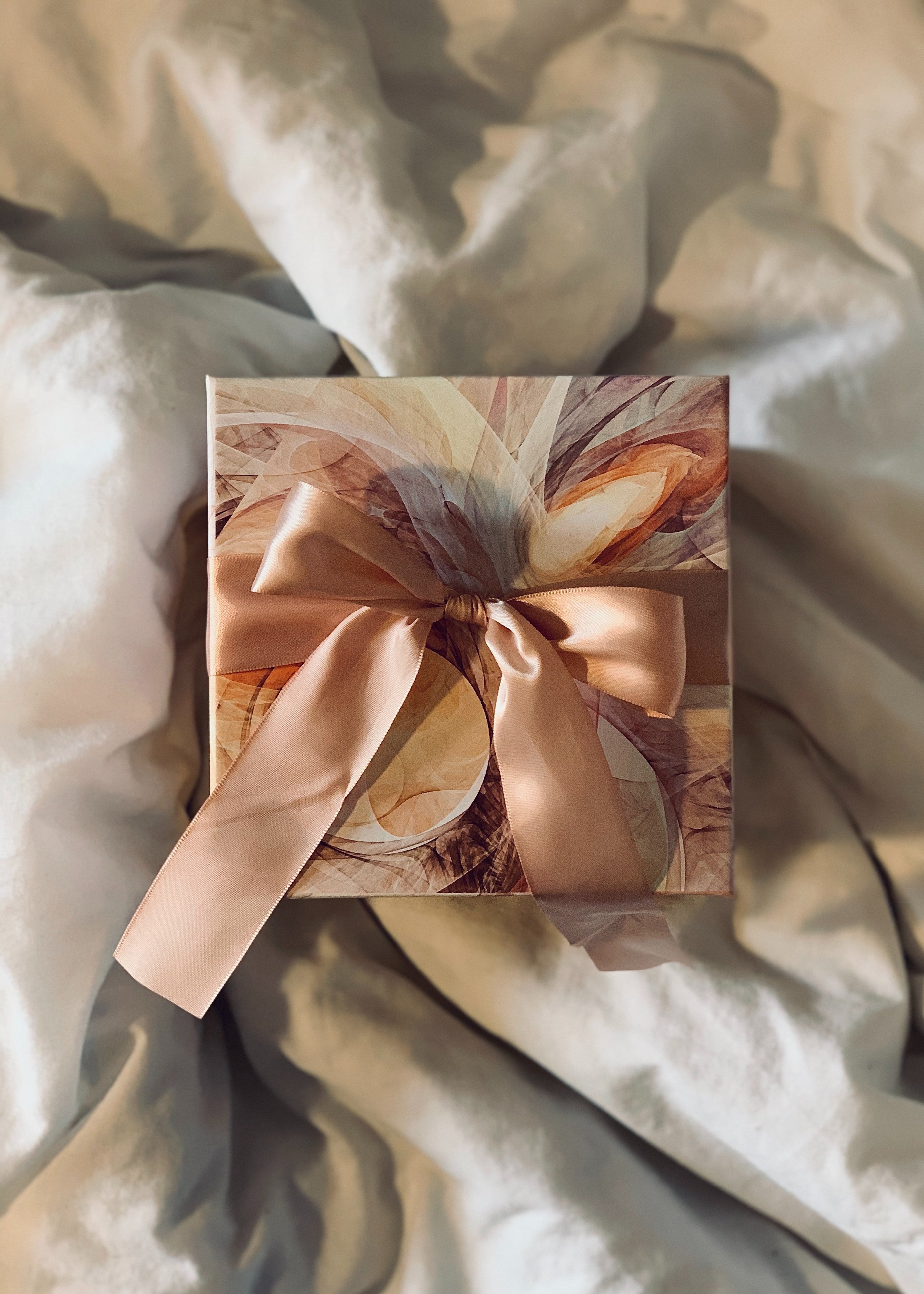brown gift wrapped and placed against brown crumpled sheet